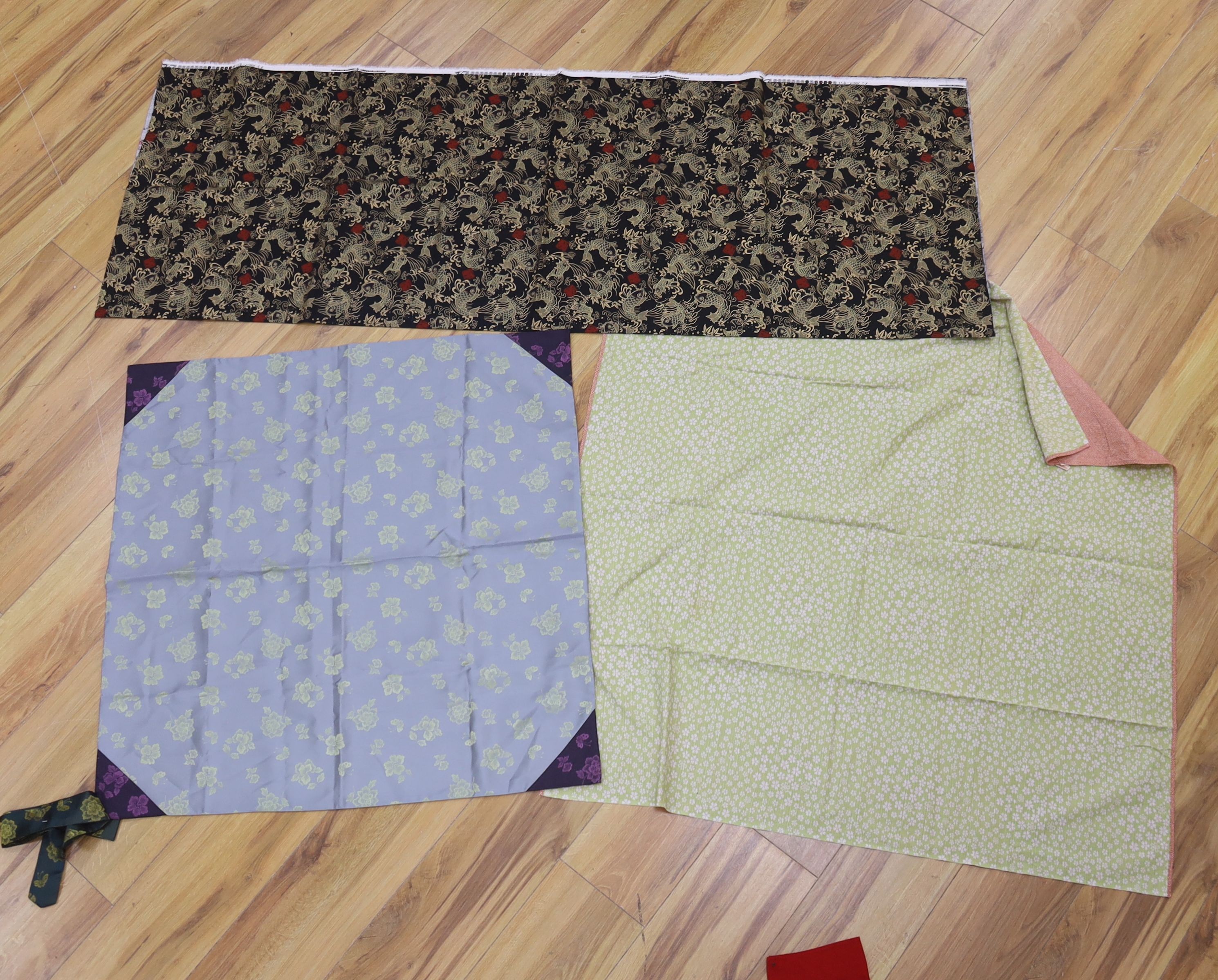 Two Japanese kite flags and various obi's and textiles